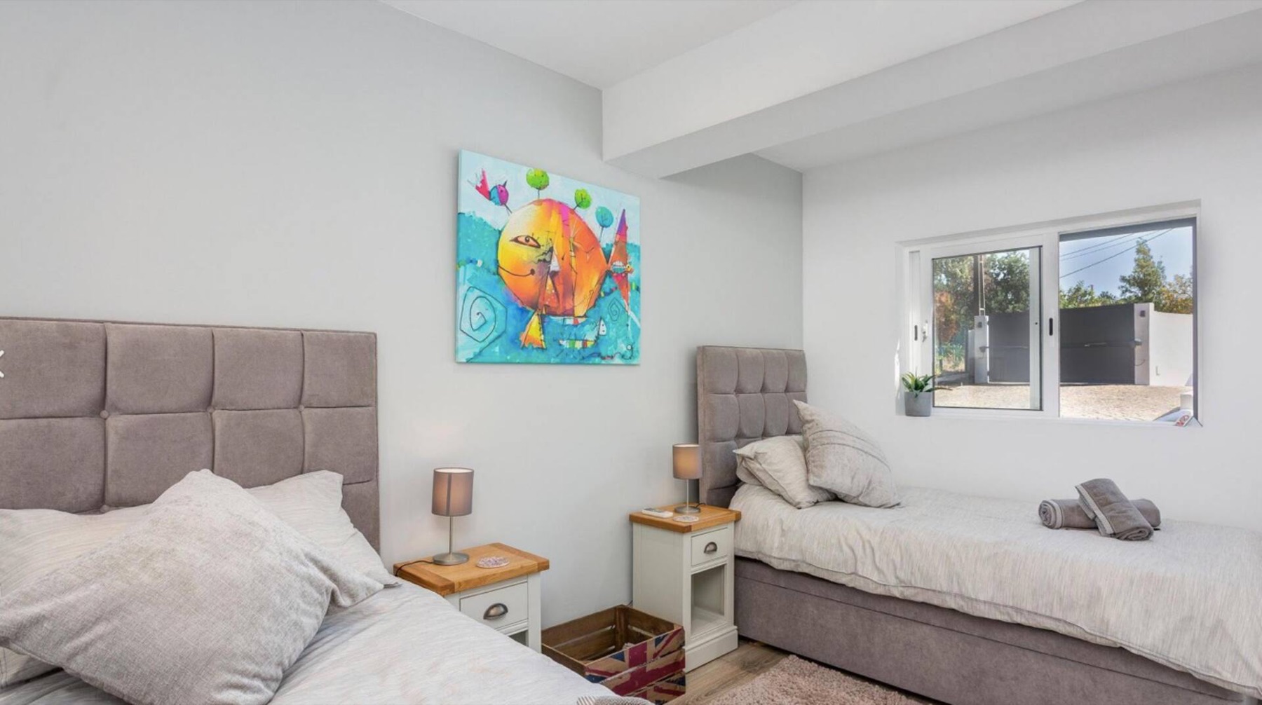Villa Verde twin bedroom with colourful artwork